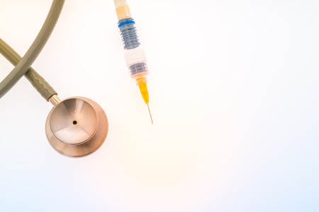 Plastic syringe with  stethoscope  ( Filtered image processed colorful effect. )の写真素材