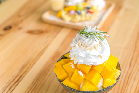 Korean style fresh mango shaved ice on wood tableの写真素材