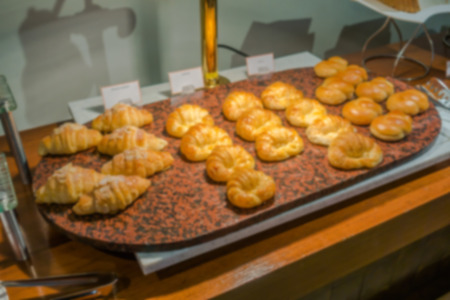 Abstract blur Croissant bread on table in buffetの写真素材