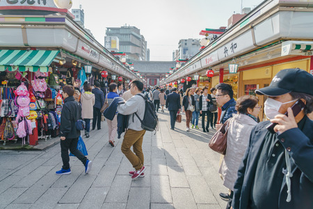 TOKYO,JAPAN - 24 November  2015 :Tourists walk on Nakamise Dori in Sensoji shrine.Sensoji temple with a variety of traditional, local snacks and tourist souvenirs for centuries.のeditorial素材