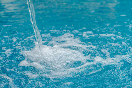 Blue swimming pool rippled waterの写真素材