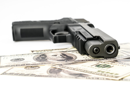 Close up image of pistol and dollarの写真素材