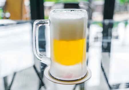 Mug with beer on tableの写真素材