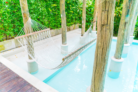 White hammocks in Luxury swimming poolの写真素材
