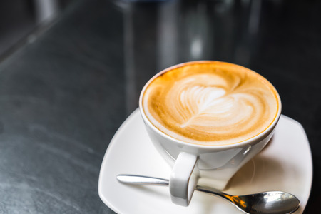 Latte Coffee art on the tableの写真素材