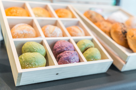 Brightly colored cakes in refrigeratorの写真素材