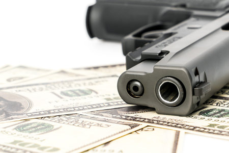 Close up image of pistol and dollar
