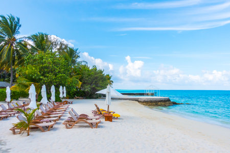 Beach chairs with umbrella at Maldives island with white sandy beach and seaの写真素材