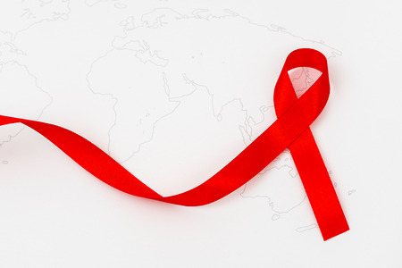 Aids Awareness Red heart Ribbon on world mapの写真素材
