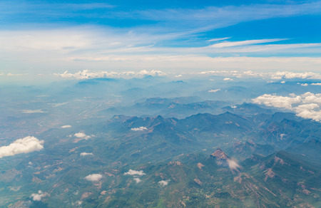 Mountains under clouds. View from the airplaneの写真素材
