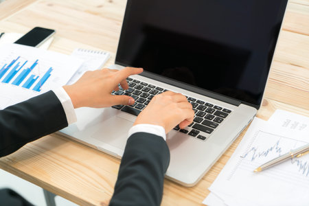 Business people using laptop and Financial charts at meeting office