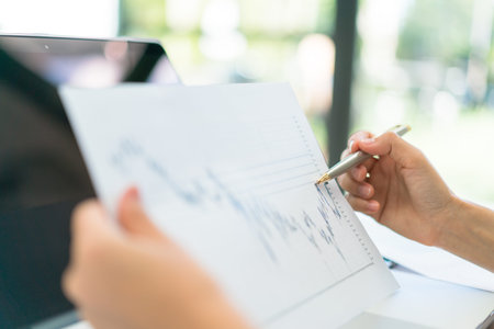 Business people using laptop and Financial charts at meeting office
