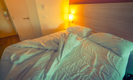 Bed and pillow after used  ( Filtered image processed vintage effect. )の写真素材