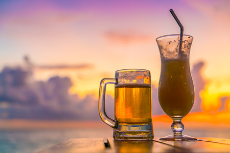 A glass of beer with Beautiful tropical Maldives islandの写真素材