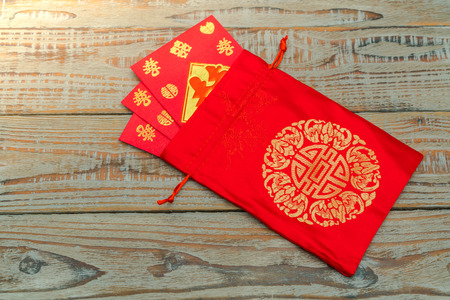 Chinese New Year decoration on wood wall,Chinese characters text means: rich, successfully, happiness, peace, riches and honour, auspicious , good luckの写真素材