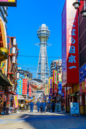 OSAKA, JAPAN - NOVEMBER 30, 2015: Tsutenkaku Tower in Shinsekai (new world) district with blue sky. It is a tower and well-known landmark of Osaka, Japan and advertises Hitachi.のeditorial素材