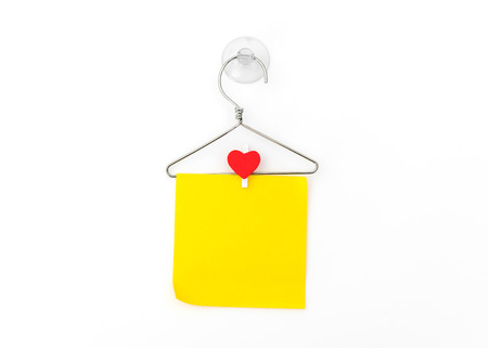 Red paper heart hanging on white backgroundの写真素材