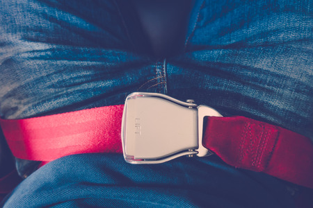 Close up of safety seat belt in the airplane ( Filtered image processed vintage effect. )の写真素材