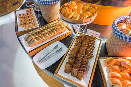 Assortment of fresh pastry on table in buffetの写真素材