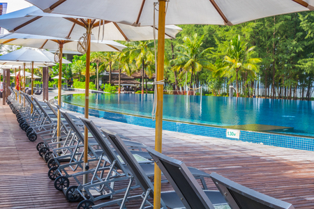 Swimming pool with relaxing seats near the seaのeditorial素材