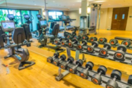Abstract blur Fitness center with traineger equipments