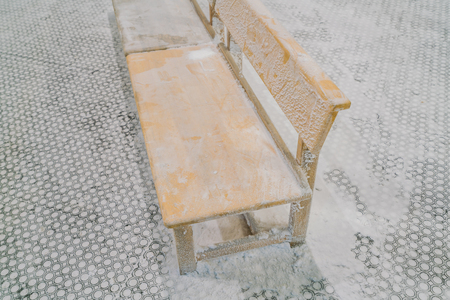 Empty chairs covered with snow in winterの写真素材