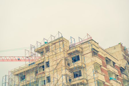 Crane and building construction site ( Filtered image processed vintage effect. )の写真素材
