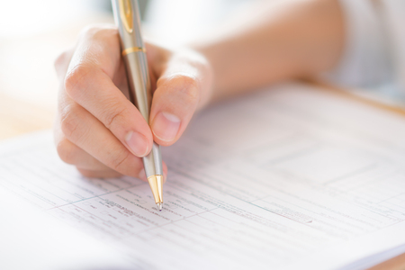 Hand with pen over application form .の写真素材
