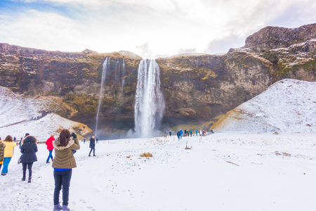 ICELAND - MARCH 15, 2017: Unidentified people at Beautiful famous waterfall in Iceland, winter season .のeditorial素材
