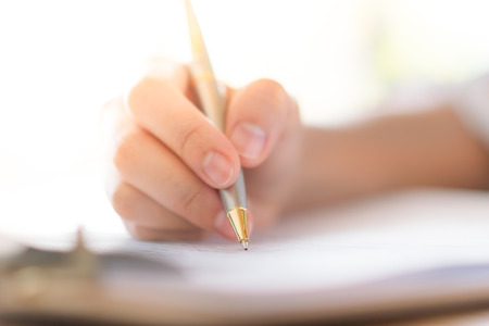 Hand with pen over application form .の写真素材