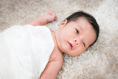 Cute newborn girl on a blanket.の写真素材