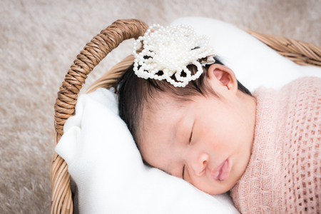 Cute sleeping newborn girl on a blanket.の写真素材