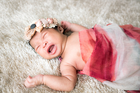 Cute newborn girl on a blanket.の写真素材