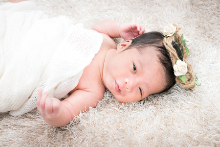 Cute newborn girl on a blanket.の写真素材