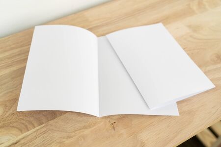 A4 half-fold brochure blank white template for mock up and presentation design on wooden surface. の写真素材