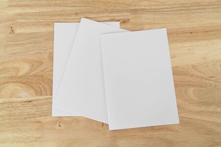 A4 half-fold brochure blank white template for mock up and presentation design on wooden surface. の写真素材