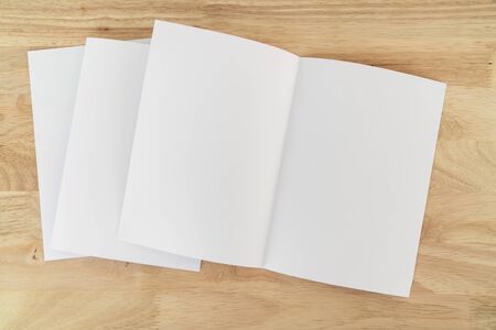 A4 half-fold brochure blank white template for mock up and presentation design on wooden surface.の写真素材