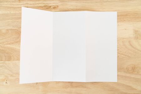 A4 tri-fold brochure blank white template for mock up and presentation design on wooden surface.の写真素材