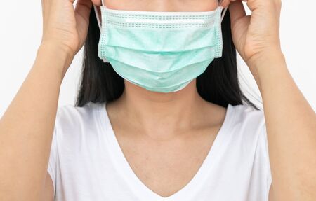 A woman wears a face mask that protects against the spread of Coronavirus (COVID-19). Surgical mask. Medical mask. Face mask.の写真素材