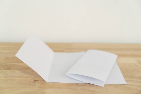 A4 tri-fold brochure blank white template for mock up and presentation design on wooden surface.の写真素材
