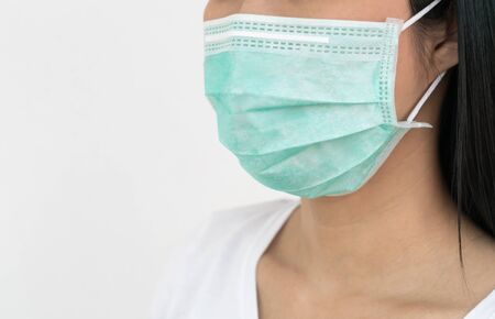 A woman wears a face mask that protects against the spread of Coronavirus (COVID-19). Surgical mask. Medical mask. Face mask.の写真素材