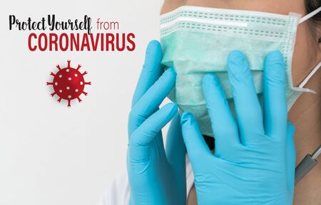 Surgical mask.  A woman wears a face mask that protects against the spread of Coronavirus (COVID-19).の写真素材