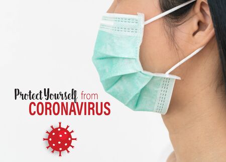 Surgical mask.  A woman wears a face mask that protects against the spread of Coronavirus (COVID-19).の写真素材