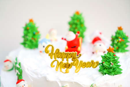 Christmas cake decorated with sweet figures of Christmas tree, Santa and sleigh.の写真素材