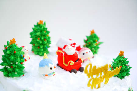 Christmas cake decorated with sweet figures of Christmas tree, Santa and sleigh.の写真素材