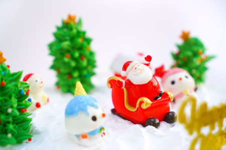 Christmas cake decorated with sweet figures of Christmas tree, Santa and sleigh.の写真素材