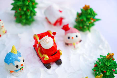 Christmas cake decorated with sweet figures of Christmas tree, Santa and sleigh.の写真素材
