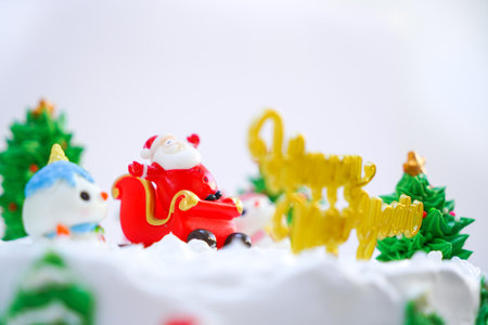 Christmas cake decorated with sweet figures of Christmas tree, Santa and sleigh.の写真素材