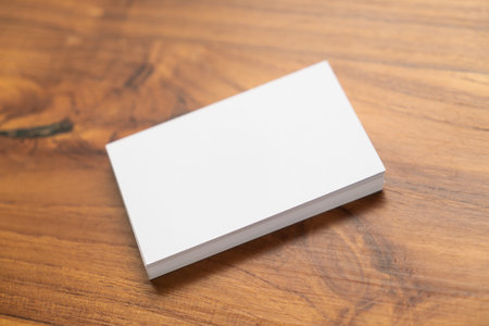 Blank mock up (business card) and cup of coffee on wooden background. Mock up for design.の写真素材