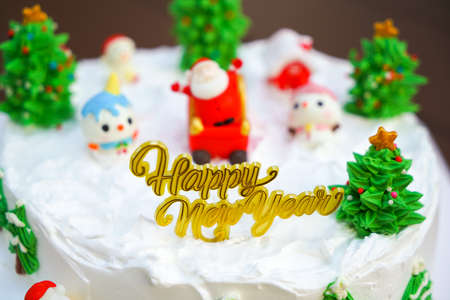 Christmas cake decorated with sweet figures of Christmas tree, Santa and sleigh.の写真素材